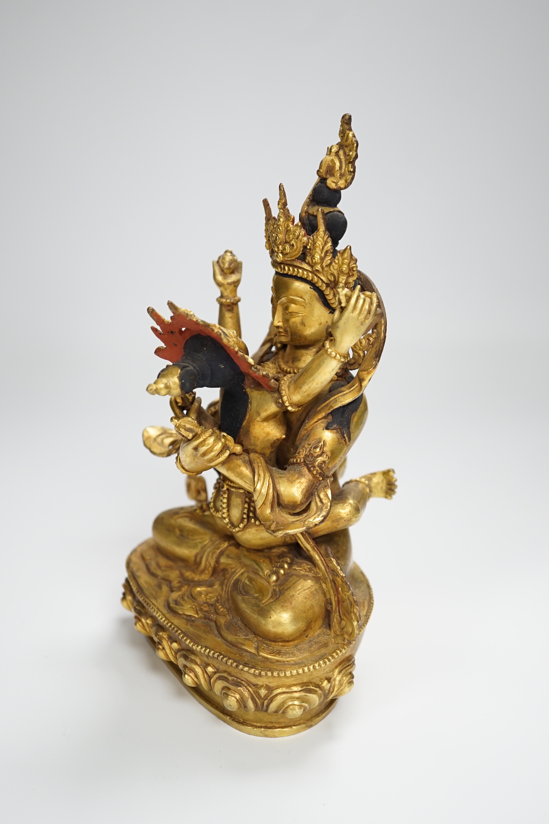 A Sino Tibetan gilt bronze group of a deity with consort, 22.5cm high